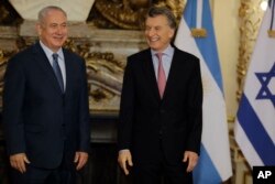 Israeli Prime Minister Benjamin Netanyahu, left, laughs with Argentina's President Mauricio Macri, as they pose for a picture, in Buenos Aires, Sept. 12, 2017.