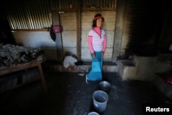 Margot Portilla stands in the kitchen of her home in the town of Nueva Fuerabamba in Apurimac, Peru, Oct. 3, 2017.