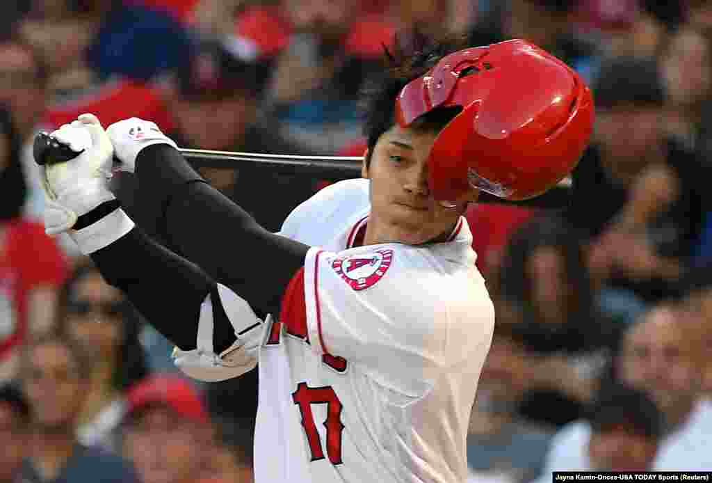 Los Angeles Angels designated hitter Shohei Ohtani (17) loses his batting helmet while swinging on a foul ball against the Houston Astros in the first inning at Angel Stadium of Anaheim, California, July 15, 2019.