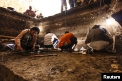 Archaeological excavations of Holocene deposits at Liang Bua on the Indonesian island of Flores are seen in progress in this undated handout picture courtesy of the Liang Bua Team.