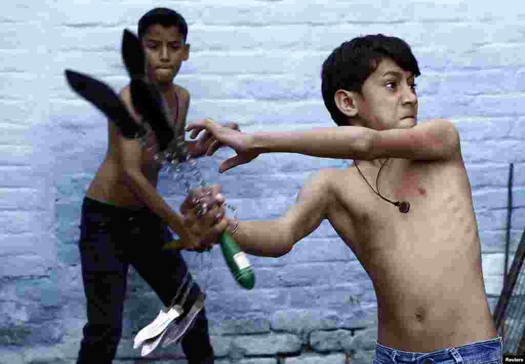 Shia Muslim boys flagellate themselves during a Muharram procession ahead of Ashura in Amroha, in the northern Indian state of Uttar Pradesh. Ashura, which falls on the 10th day of the Islamic month of Muharram, commemorates the death of Imam Hussein, grandson of Prophet Mohammad, who was killed in the 7th century battle of Kerbala.