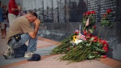 Mourners place roses and pay their final respects to Capt. Michael Scott Speicher at the Jacksonville Veterans Memorial Wall. Speicher was killed when his F/A-18 Hornet was shot down over Anbar province, Iraq, on the first day of offensive operations dur