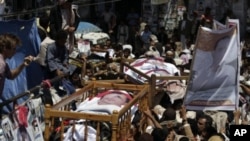 Anti-government protestors carry the bodies of those who were killed during recent clashes with security forces during their funeral procession in Sanaa, Yemen, September 25, 2011.