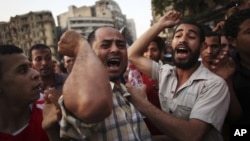 Egyptian protesters chant slogans against the country's ruling military council and presidential candidate Ahmed Shafiq in Tahrir Square in Cairo, Egypt, Thursday, June 14, 2012.