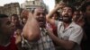 Egyptian protesters chant slogans against the country's ruling military council and presidential candidate Ahmed Shafiq in Tahrir Square in Cairo, Egypt, Thursday, June 14, 2012.