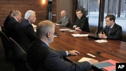 Russian President Dmitry Medvedev, right, speaks at his meeting with leaders of parties that won seats in the State Duma, in the Gorki residence outside Moscow, December 13, 2011.