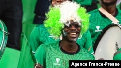 A Nigeria supporter cheers prior to the Group D Africa Cup of Nations (CAN) 2021 football match between Nigeria and Sudan at Stade Roumde Adjia in Garoua, Jan. 15, 2022.