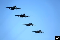 FILE - Russian Su-25 ground attack jets prepare to land after return from Syria at a Russian air base in Primorsko-Akhtarsk, southern Russia, March 16, 2016.