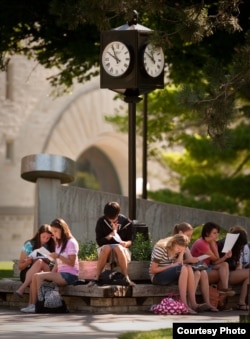 Students sit outside on the Kansas State University campus in Manhattan, Kansas.