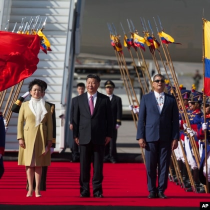 China's President Xi Jinping, center, and his wife Peng Liyuan stand with Ecuador's President Rafael Correa, during a welcoming ceremony in Quito, Ecuador, on Nov. 17, 2016. (AP) 