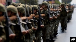 FILE - Turkish soldiers take part in the annual military parade in the Turkish-controlled northern part of Nicosia in this ethnically divided island of Cyprus, July 20, 2016.