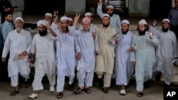 Leaders of a Bangladeshi Islamic group flash victory signs after Bangladesh's top court rejected a 28-year-old petition Monday to remove Islam as the official religion of the Muslim-majority South Asian nation in Dhaka, Bangladesh, March 28, 2016.