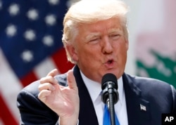 FILE - President Donald Trump speaks about the health care vote during a joint news conference with Lebanese Prime Minister Saad Hariri in the Rose Garden of the White House in Washington, July 25, 2017.