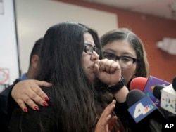 Marlene Mosqueda, left, who's father was deported Feb. 10, 2017, is comforted at a news conference by her attorney Karla Navarrette at The Coalition for Humane Immigrant Rights of Los Angeles.