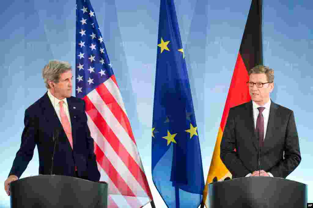 German Foreign Minister Guido Westerwelle gives a statement as U.S. Secretary of State John Kerry listens at the Foreign Ministry in Berlin, Feb. 26, 2013.