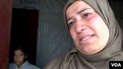 Khalisa Sabri Ali weeps as she talks about her son, the sole breadwinner in her family of seven (VOA).