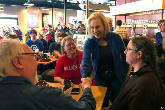 Sen. Kirsten Gillibrand, D-N.Y. greets patrons at Stomping Grounds Cafe in Ames, Iowa, Jan. 19, 2019.