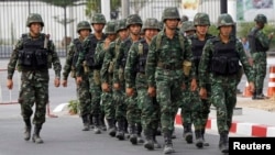 Soldiers walk outside the National Anti-Corruption Commission office in Nonthaburi province, on the outskirts of Bangkok, Feb. 27, 2014. 