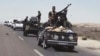 FILE - Iraqi forces backed by Shi'ite and Sunni pro-government fighters prepare to attack Islamic State group positions in Fallujah, 40 miles (65 kilometers) west of Baghdad, Iraq, Monday, July 13, 2015. Fallujah was the first city in Iraq to fall to IS extremists in January 2014 and the group is still well entrenched there.