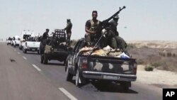 FILE - Iraqi forces backed by Shi'ite and Sunni pro-government fighters prepare to attack Islamic State group positions in Fallujah, 40 miles (65 kilometers) west of Baghdad, Iraq, Monday, July 13, 2015. Fallujah was the first city in Iraq to fall to IS extremists in January 2014 and the group is still well entrenched there.