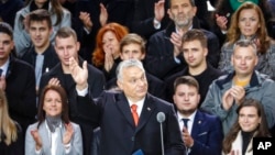 Hungarian Prime Minister Viktor Orban waves to supporters during celebration the 65th anniversary of the 1956 Hungarian revolution, in Budapest, Hungary, Saturday, Oct. 23, 2021.
