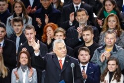 FILE - Hungarian Prime Minister Viktor Orban waves to supporters during a celebration of the 65th anniversary of the 1956 Hungarian revolution, in Budapest, Hungary, Oct. 23, 2021.