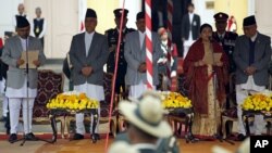 FILE - Kalyan Shrestha, left, Nepal's chief justice at the time, administers the presidential oath of office to Bidhya Bhandari, fourth from left, at the presidential building in Kathmandu, Oct. 29, 2015. Shrestha retired Tuesday, and Sushila Karki was named his successor.