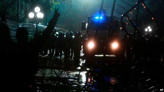 Police block the road near the Parliament building during clashes in Tirana, Albania, May 13, 2019.