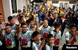 People react as the 12 soccer players and their coach who were rescued from a flooded cave as they arrive for their news conference in the northern province of Chiang Rai, Thailand, July 18, 2018. REUTERS/Soe Zeya Tun