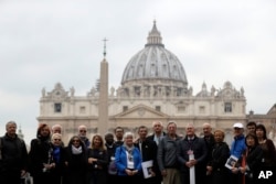 Members of the ECA (Ending of Clergy Abuse) organization and survivors of clergy sex abuse pose for photographers outside St. Peter's Square, at he Vatican, Feb. 18, 2019.