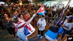 Members of the Cuban community dance in the street as they react to the death of Fidel Castro in front of the Versailles Restaurant in the Little Havana neighborhood of Miami, Nov. 26, 2016.