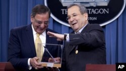 Israeli Defense Minister Ehud Barak presents Defense Secretary Leon Panetta with a model replica of an Iron Dome Missile Defense rocket during their joint news conference at the Pentagon, Thursday, Nov. 29, 2012.