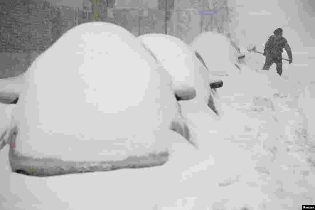 A man shovels snow during a winter storm in Ottawa, Canada, Feb. 16, 2016.