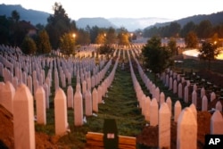 FILE - Gravestones are seen at sunrise at a memorial complex near Srebrenica, 150 kilometers (94 miles) northeast of Sarajevo, Bosnia-Herzegovina, July 11, 2015. Twenty years earlier, Serb troops overran the eastern Bosnian Muslim enclave of Srebrenica and executed 8,000 Muslim men and boys, which International courts have labeled as an act of genocide.