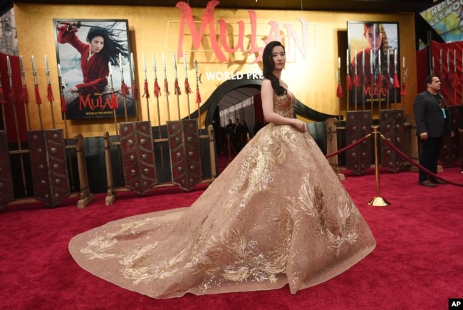 In this March 9, 2020, file photo, Yifei Liu, star of the new live-action "Mulan," poses at the premiere of the film at the El Capitan Theatre in Los Angeles, California. (AP Photo/Chris Pizzello, File)