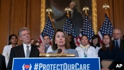 Speaker of the House Nancy Pelosi, D-Calif., joined at left by Energy and Commerce Committee Chair Frank Pallone, D-N.J., speaks at an event to announce legislation to lower health care costs and protect people with pre-existing medical conditions, Washington, March 26, 2019. 