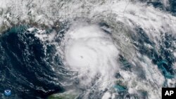  Oct. 9, 2018 satellite image provided by NOAA shows Hurricane Michael, center, in the Gulf of Mexico. (NOAA via AP)