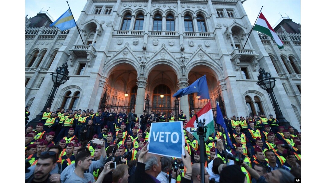 FILE - Demonstrators face policemen as they protest against the amendment of the higher education law seen by many as an action aiming at the closure of the Central European University, in Hungary, April 4, 2017.
