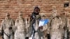 FILE - Leader of one of the Boko Haram group's factions, Abubakar Shekau speaks in front of guards in an unknown location in Nigeria in this still image taken from an undated video obtained on Jan. 15, 2018. 