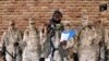 FILE - Leader of one of the Boko Haram group's factions, Abubakar Shekau speaks in front of guards in an unknown location in Nigeria in this still image taken from an undated video obtained on Jan. 15, 2018. 