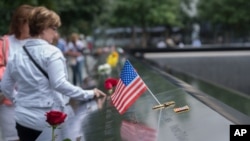 Visitors touch the names of the victims of the Sept. 11, 2001, terror attacks at New York's National September 11 Memorial, Sept. 11, 2015. Survivors and relatives of the nearly 3,000 people killed in the attacks might be able to soon sue Saudi Arabia for damages.