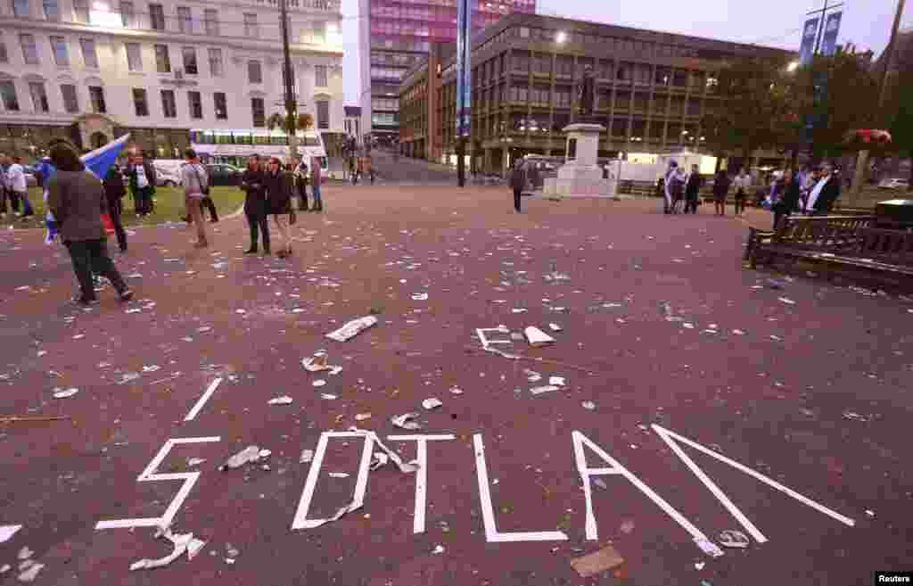 The remnants of a message written in tape by "Yes" campaign supporters is seen in George Square after Scotland voted against becoming an independent country, in Glasgow, Scotland, Sept. 19, 2014.