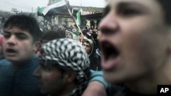 Protesters chant anti-government slogans in the village of Kansafra in the Jabal al-Zawiya region of the northern province of Idlib, December 9, 2011.