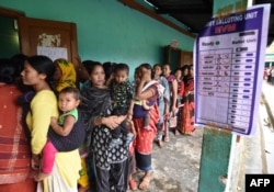 Indian voters queue to cast their ballots in the state assembly elections at a polling station in Diphu in the Karbi Anglong district some 215kms from Guwahati on April 4, 2016.