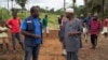 Kande-Bure Kamara from WHO speaks with community leaders at the construction site of a Ebola Care Unit in Kamasondo Village, Port Loko District, Oct. 8, 2014.