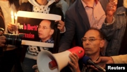 FILE - Maati Monjib, a professor of political history and African studies at the University of Rabat and a writer for national and international news organisations, and his supporters participate in a demonstration near the Moroccan Human Rights Associati