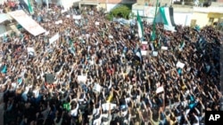 Demonstrators protest Syrian President Bashar al-Assad in Hula, Nov. 13, 2011.