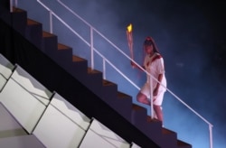 FILE - Tennis champion Naomi Osaka lights up Olympic cauldron July 23, 2021