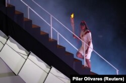 FILE - Tennis champion Naomi Osaka lights up Olympic cauldron July 23, 2021