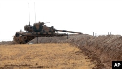 A Turkish tank is stationed near the Syrian border, in Karkamis, Turkey, Aug. 29, 2016. 